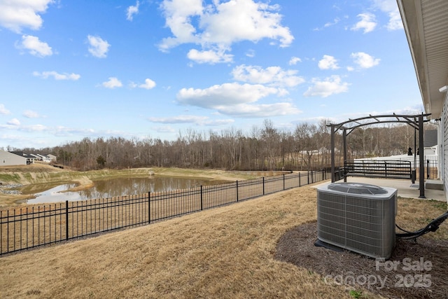 view of yard with central AC unit, a pergola, and a water view