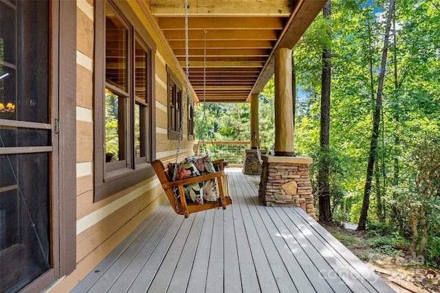 wooden terrace featuring covered porch