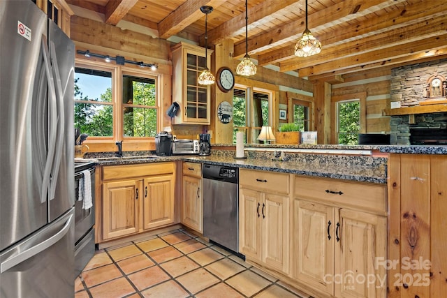 kitchen featuring sink, wood ceiling, hanging light fixtures, stainless steel appliances, and dark stone counters