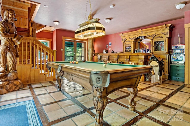 game room featuring pool table, french doors, and bar area