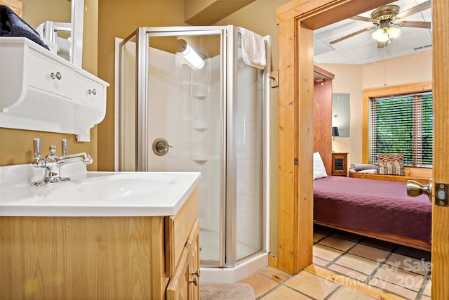 bathroom featuring walk in shower, ceiling fan, vanity, and tile patterned flooring