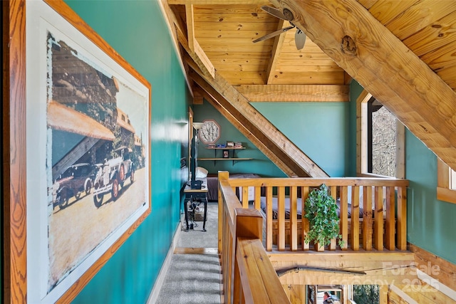 stairs with beamed ceiling, ceiling fan, and wood ceiling