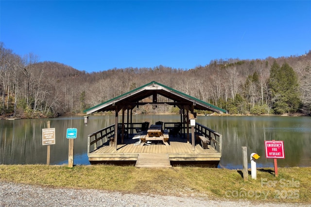 view of dock with a gazebo and a water view