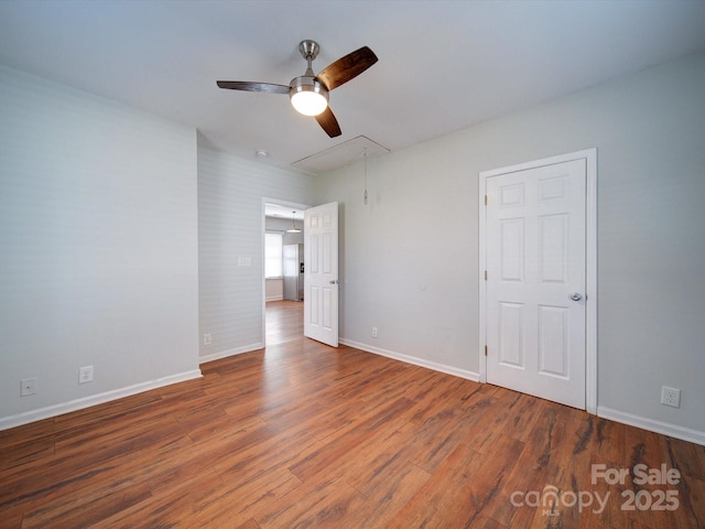 unfurnished bedroom featuring dark wood-type flooring and ceiling fan