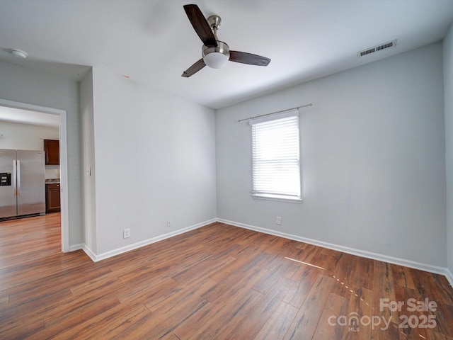 unfurnished room with ceiling fan and hardwood / wood-style floors