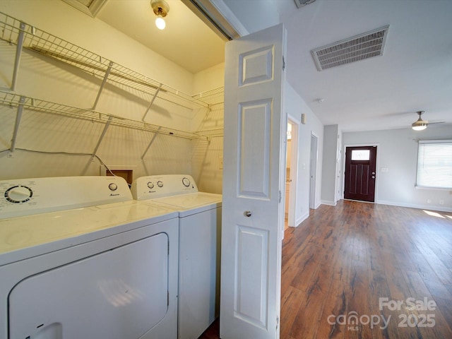 clothes washing area featuring separate washer and dryer, dark wood-type flooring, and ceiling fan