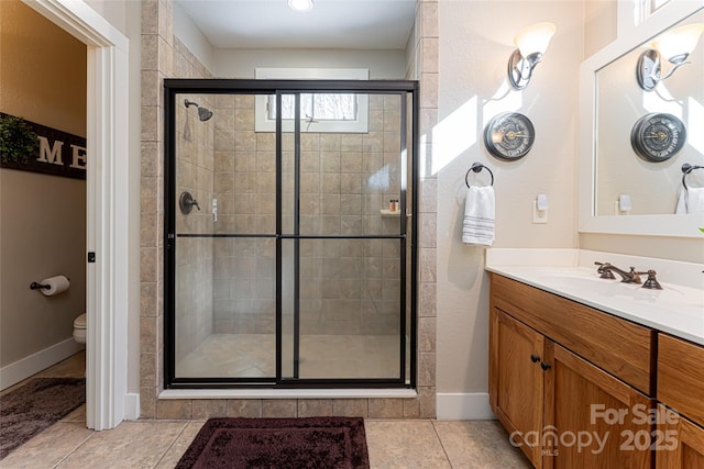 bathroom with vanity, toilet, tile patterned flooring, and a shower with door