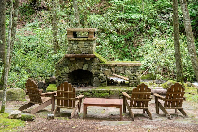 view of patio / terrace featuring an outdoor stone fireplace