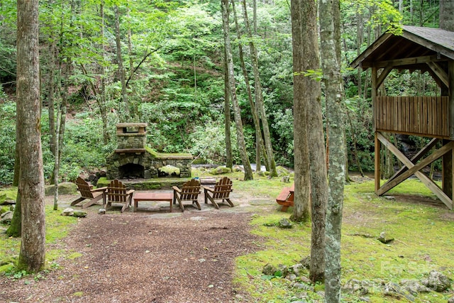 view of yard with an outdoor stone fireplace