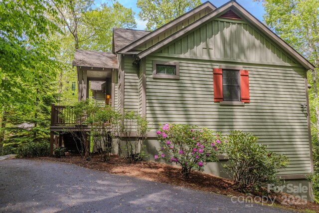 142 Allspice Ct, Tuckasegee, NC 28783 - view of side of home featuring board and batten siding, a deck, and a shingled roof