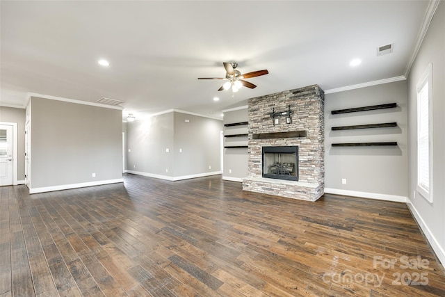 unfurnished living room with dark wood-type flooring, visible vents, a fireplace, and crown molding