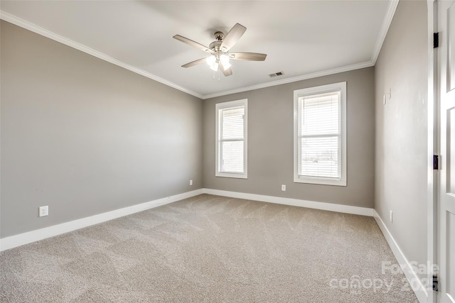 unfurnished room with baseboards, visible vents, a ceiling fan, ornamental molding, and carpet floors