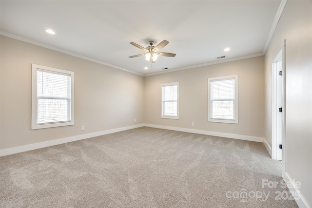 spare room featuring baseboards, light colored carpet, and crown molding