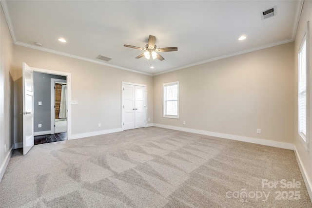 unfurnished bedroom featuring baseboards, visible vents, and ornamental molding