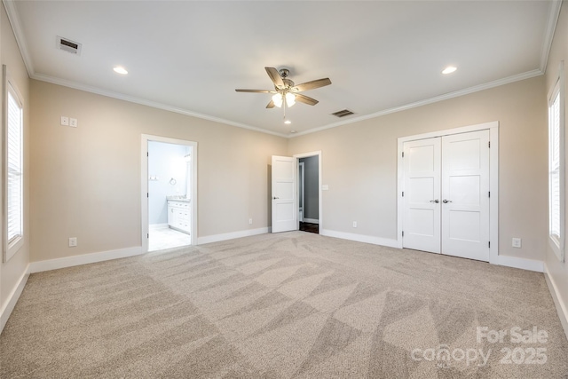 unfurnished bedroom with light carpet, baseboards, visible vents, and ornamental molding