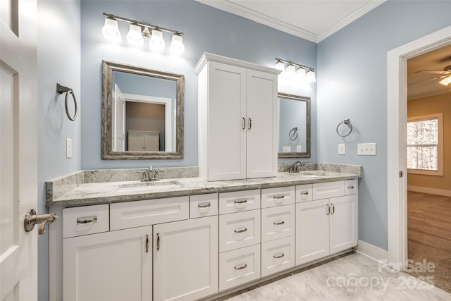 full bath featuring crown molding, a sink, and double vanity