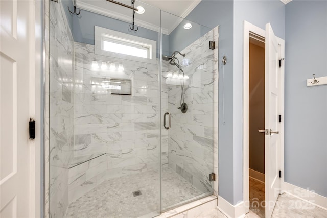 bathroom with ornamental molding, a stall shower, marble finish floor, and baseboards