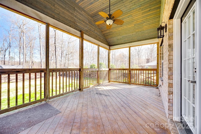 unfurnished sunroom with lofted ceiling and ceiling fan