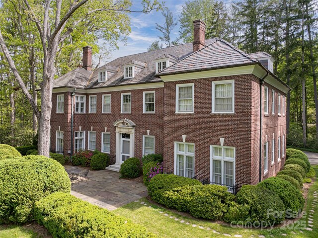 407 Vanderbilt Rd, Asheville, NC 28803 - colonial home with a high end roof, brick siding, and a chimney