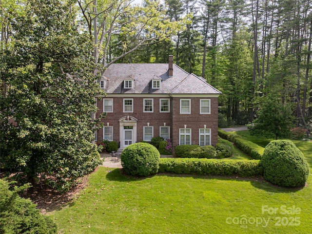 407 Vanderbilt Rd, Asheville, NC 28803 - view of front facade featuring a chimney, a front lawn, and brick siding