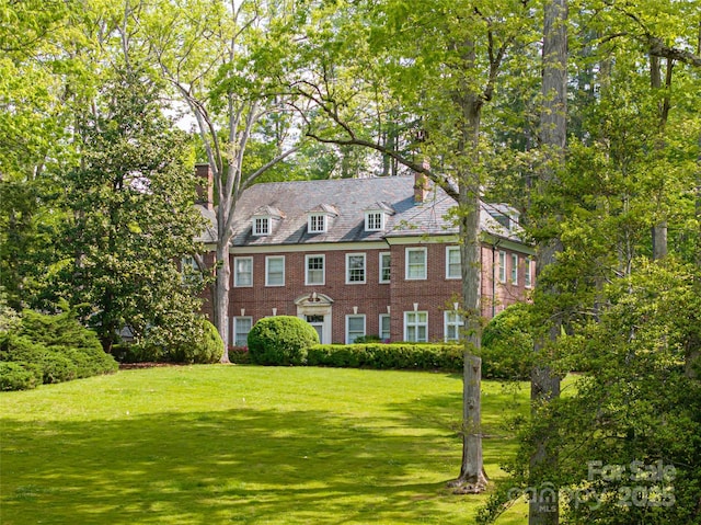 407 Vanderbilt Rd, Asheville, NC 28803 - view of front of property with brick siding, a chimney, and a front yard