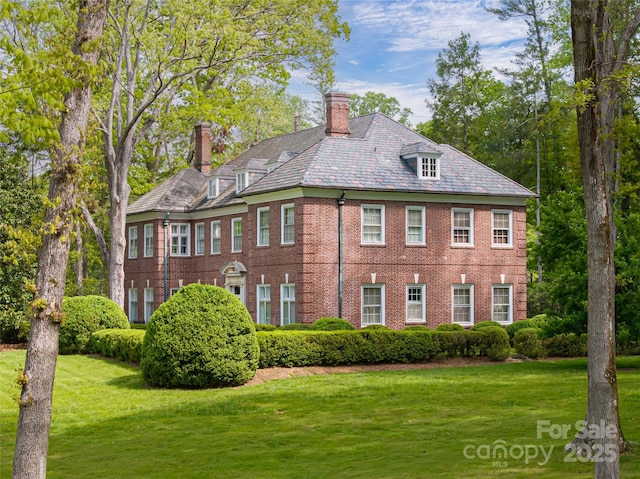 407 Vanderbilt Rd, Asheville, NC 28803 - view of front of house featuring a chimney, a front yard, a high end roof, and brick siding