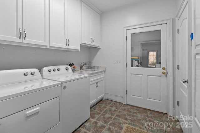 laundry room featuring washer and clothes dryer, a sink, and cabinet space