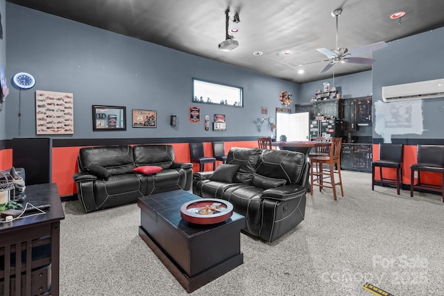 living area featuring a ceiling fan, an AC wall unit, and speckled floor