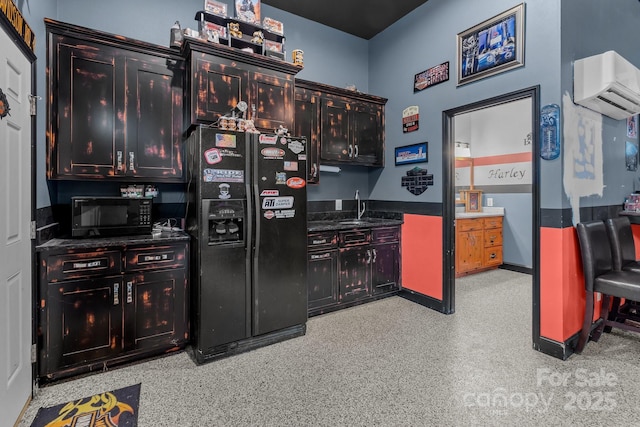 kitchen featuring dark countertops, black appliances, a sink, and a wall mounted AC