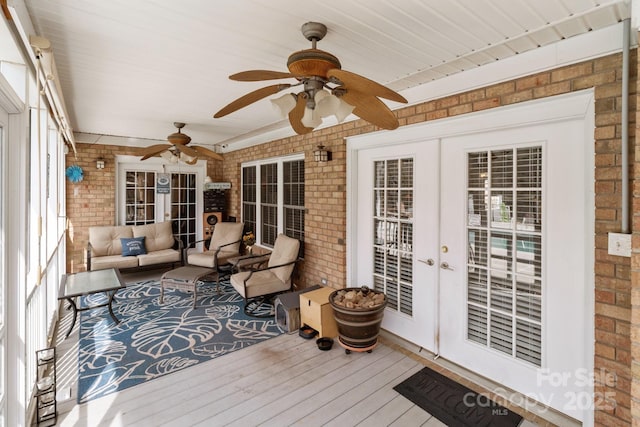 sunroom / solarium featuring french doors