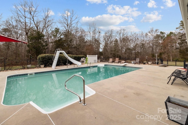 view of pool with a water slide, a patio area, fence, and a fenced in pool