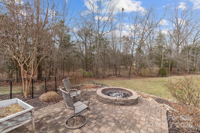 view of patio / terrace with an outdoor fire pit and fence