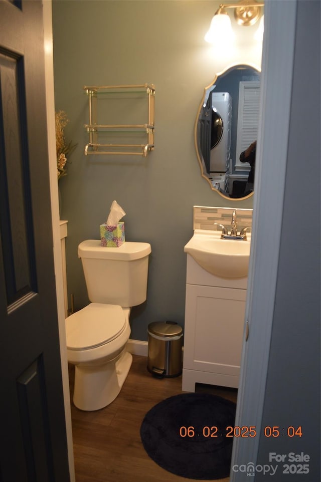 bathroom featuring wood-type flooring, vanity, and toilet