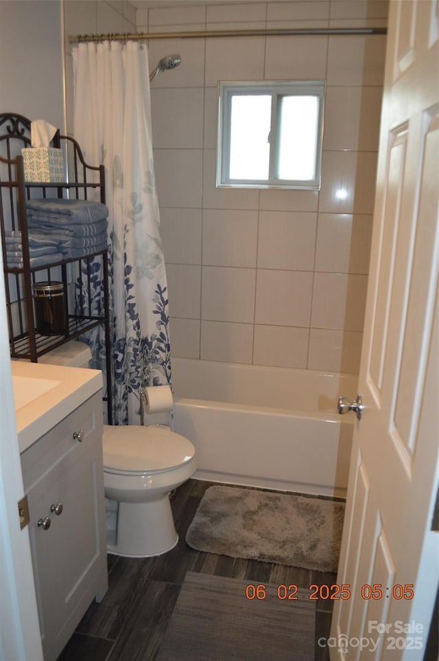 full bathroom with toilet, vanity, shower / bathtub combination with curtain, and hardwood / wood-style floors