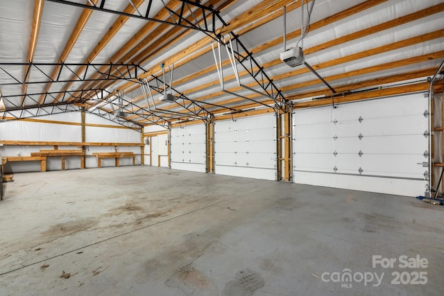 garage featuring metal wall and a garage door opener