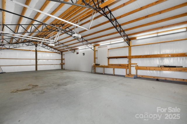 garage with a garage door opener and metal wall