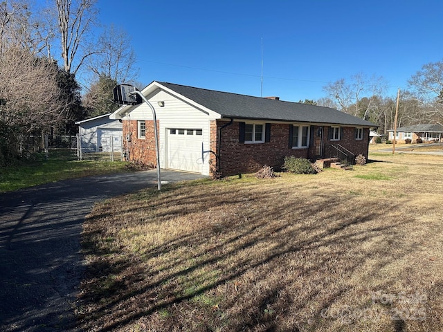 view of home's exterior featuring a yard, a garage, and central AC unit