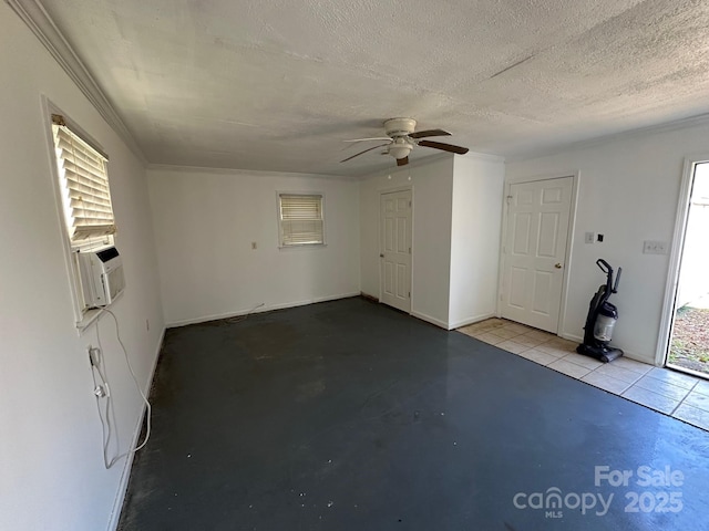 unfurnished room with ceiling fan, cooling unit, and a textured ceiling