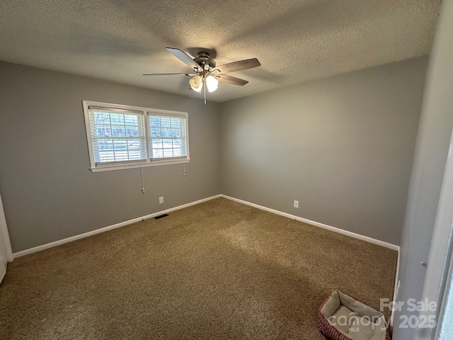 carpeted empty room featuring a textured ceiling and ceiling fan