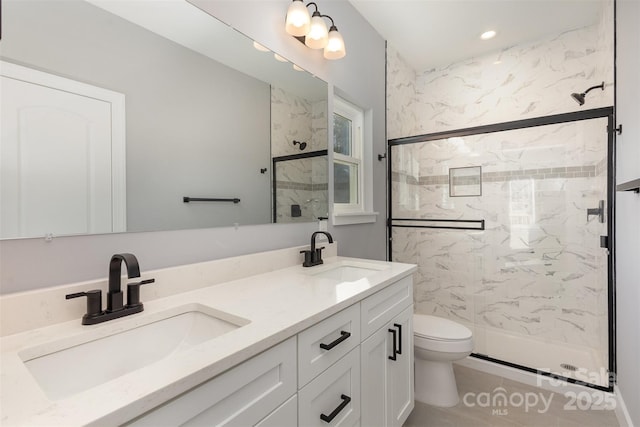 bathroom with vanity, an enclosed shower, and toilet