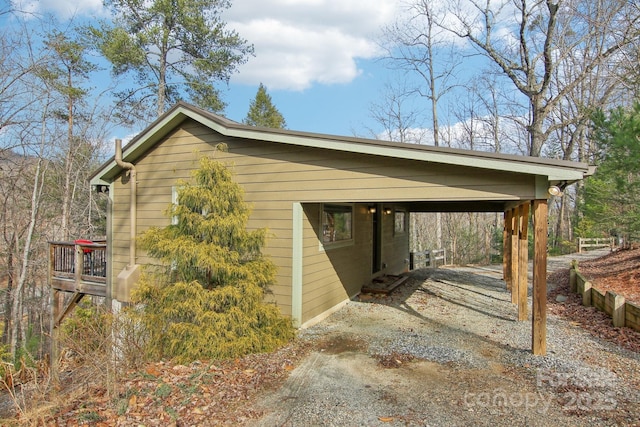 view of side of home with a carport