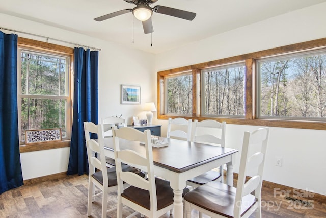 dining area featuring hardwood / wood-style floors and ceiling fan