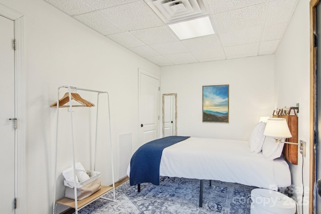 bedroom featuring a drop ceiling