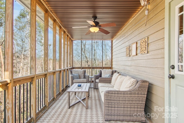 sunroom featuring ceiling fan