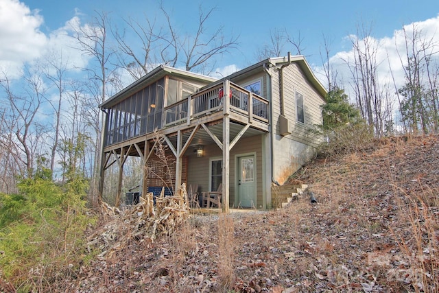 rear view of property featuring a sunroom