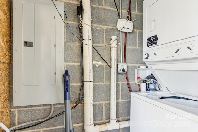 interior space featuring electric panel and stacked washer / dryer