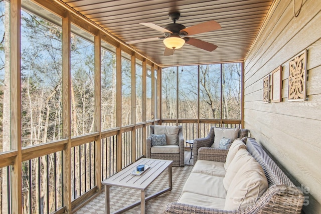 sunroom featuring a ceiling fan