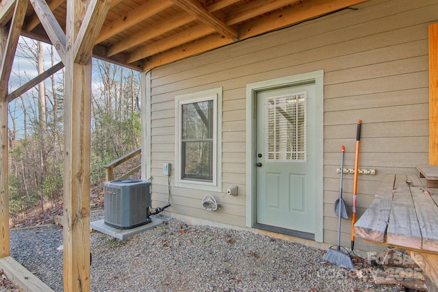 view of exterior entry featuring central AC unit