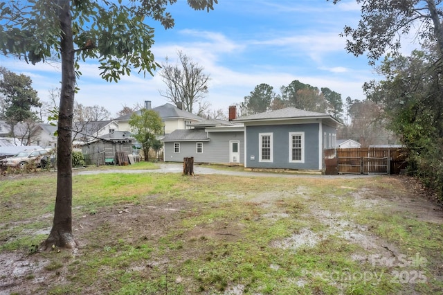 rear view of house with a lawn