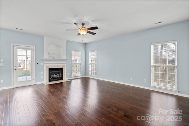 unfurnished living room with ceiling fan and dark hardwood / wood-style flooring